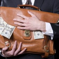 Businessman with a briefcase full of money