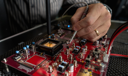 Hand of a man manipulating electronic circuits