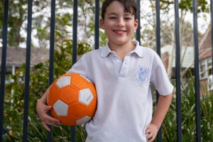 Student Nash Cazilieris, 7, plays with ball he'll no longer be allowed to bring to school. Summer Hill Public Schools ...