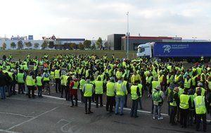 File - Gilets Jaunes (Yellow Jackets) protesters demonstrate at a round-about in Vaugine à Vesoul, Haute-Saône, France, hence blocking the N19 in both directions, 17 November 2018.