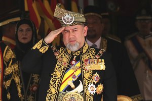 FILE - In this July 17, 2018, file photo, Malaysian King Sultan Muhammad V salutes during the national anthem at the opening of the 14th parliament session at the Parliament house in Kuala Lumpur, Malaysia.