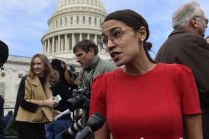 In this Nov. 14, 2018 photo, Rep.-elect Alexandria Ocasio-Cortez, D-N.Y., talks with reporters following a photo opportunity on Capitol Hill in Washington