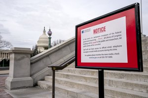 The dome of the Capitol Building is visible behind a closure sign that is posted outside of the Library of Congress in Washington, Monday, Jan. 22, 2018.