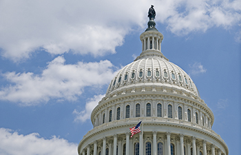 US Capitol dome against a blue sky