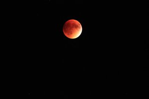 The moon turning a blood red colour during a total lunar eclipse