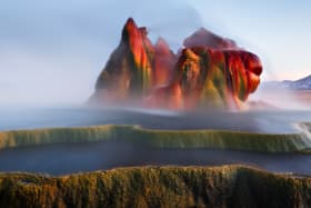 Fly Geyser near the Black Rock Desert in Nevada constantly erupts minerals and hot water creating bright colours and terraced pools.