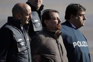 Italian fugitive Cesare Battisti arrives at Ciampino military airport, in Rome, Monday, Jan. 14, 2019.