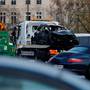 A vandalized car is removed the morning after clashes with protesters wearing yellow vests, a symbol of a French drivers' protest against higher diesel fuel taxes, in Paris, France, December 2, 2018. REUTERS/Stephane Mahe