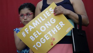 A girl stands with her mother during a Rally For Our Children event to protest a new "zero-tolerance" immigration policy that has led to the separation of families, Thursday, May 31, 2018, in San Antonio.