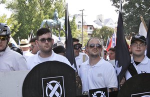 In this Saturday, Aug. 12, 2017 photo released by Alan Goffinski, James Alex Fields Jr., second from left, stands with a handful of men, all dressed similarly in the Vanguard America uniform of khakis and white polo shirts, in Charlottesville, Va. Fields, is accused of crashing into a crowd protesting a white supremacist rally in Virginia. (AP Photo/Alan Goffinski)