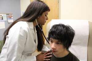 In this photo taken on Thursday, Nov. 19, 2015, American Physician Meena Hasan examines a patient in her office in Gaithersburg, Md.