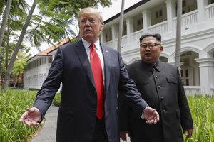 U.S. President Donald Trump and North Korea leader Kim Jong Un stop to talk with the media as they walk from their lunch at the Capella resort on Sentosa Island Tuesday, June 12, 2018 in Singapore.