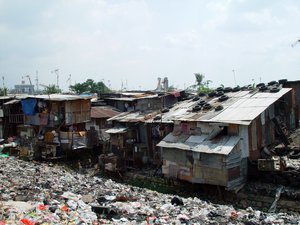 A shanty town in Jakarta, Indonesia. A shanty town (also called a squatter settlement) is a slum settlement (sometimes illegal or unauthorized) of impoverished people who live in improvised dwellings made from scrap materials: often plywood, corrugated metal and sheets of plastic.