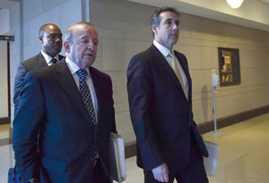 Michael Cohen, right, President Donald Trump's personal attorney walks with his attorney Stephen M. Ryan, center, on Capitol Hill in Washington, Tuesday, Oct. 24, 2017, after an interview with the House Intelligence Committee.