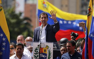 Juan Guaido, head of Venezuela's opposition-run congress, speaks to supporters at a rally where he declared himself interim president until new elections can be called in Caracas, Venezuela, Wednesday, Jan. 23, 2019