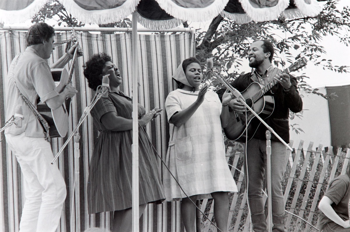 Musicians Guy Carawan, Fannie Lou Hamer, Bernice Johnson Reagon, and Len Chandler perform civil rights songs at the 1965 Newport Folk Festival.