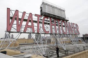 File - In this Wednesday, Dec. 9, 2015, file photo, the iconic Watchtower sign is seen on the roof of 25-30 Columbia Heights, then world headquarters of the Jehovah's Witnesses, in the Brooklyn borough of New York.