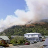 Smoke rises from a wildfire coming over the ridge behind a residential area in Wakefield, New Zealand, on Friday. 