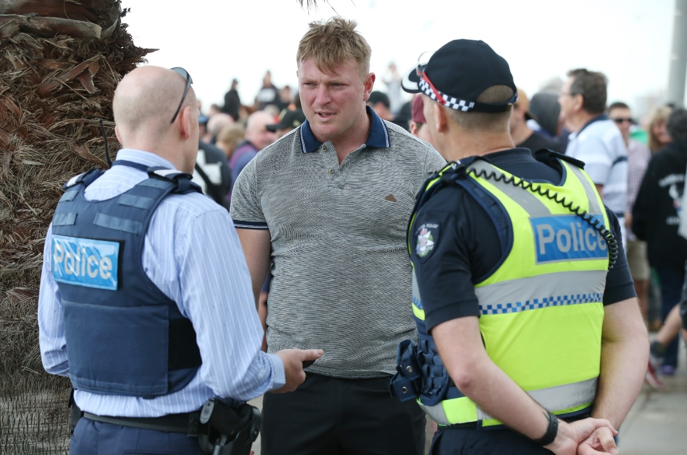 Right wing activist Blair Cottrell is seen talking to police on St Kilda foreshore in Melbourne, Saturday, January 5, 2019