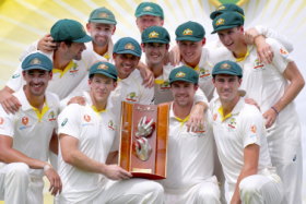 Long wait: Australia's captain Tim Paine holds the trophy as he poses with teammates after they finally broke through for a series victory.