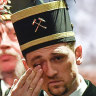 A coal miner in traditional dress wipes a tear during the closing ceremony of the last German coal mine in Bottrop, Germany, in December.