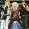 Members of the reunited metal band Twisted Sister, including Dee Snider (centre), pose for photos before a press conference in New York on April 29, 2003.