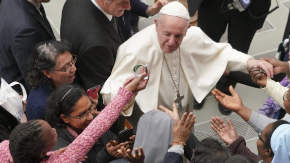 Pope Francis is greeted by a group of nuns during the weekly general audience.