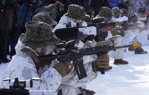 South Korean and U.S. Marines from III Marine Expeditionary Force from Okinawa, Japan, fire their machine guns during their joint military winter exercise in Pyeongchang, South Korea, Tuesday, Dec. 19, 2017.