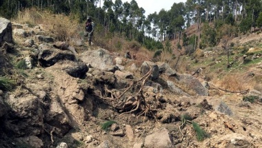 Pakistan army soldier walks near to the crater where Indian military aircrafts released payload in Jaba village, Balakot, Pakistan February 28, 2019. REUTERS/Asif Shahzad