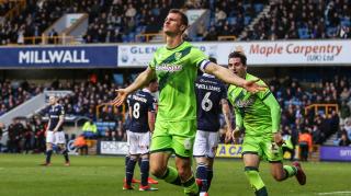 Heading to the top: Christoph Zimmermann celebrates scoring Norwich’s second goal at The Den