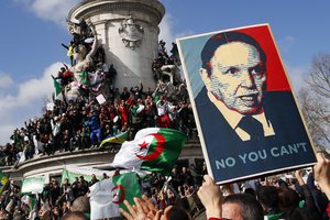 Demonstrators stage a protest to denounce President Abdelaziz Bouteflika's bid for a fifth term on Place de la Republique in Paris, Sunday, March 10, 2019.