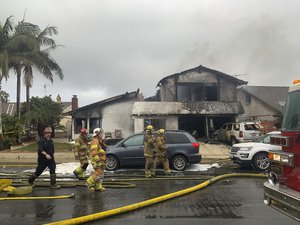 Firefighters respond to the scene of a plane crash at a home in Yorba Linda, Calif., Sunday, Feb. 3, 2019.