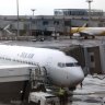 FILE - In this Oct. 4, 2017, file photo, SilkAir's new Boeing 737 Max 8 aircraft is seen through a viewing gallery window parked on the tarmac of Singapore's Changi International Airport. China's civilian aviation authority has ordered all Chinese airlines to temporarily ground their Boeing 737 Max 8 planes after one of the aircraft crashed in Ethiopia. The Civil Aviation Administration of China said the order was issued at 9 a.m. Beijing time Monday, March 11, 2019 and would last nine hours. (AP Photo/Wong Maye-E, File)