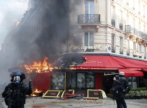 Paris famed restaurant Fouquet's burns on the Champs Elysees avenue during a yellow vests demonstration Saturday, March 16, 2019 in Paris