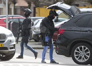 Dutch counter terrorism police prepare to enter a house after a shooting incident in Utrecht, Netherlands, Monday, March 18, 2019