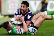 Melbourne Storm's Jahrome Hughes tackles Jack Wighton.