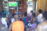 Packed house: Family and friends in Fiji gather to watch Maiko Sivo's NRL debut.