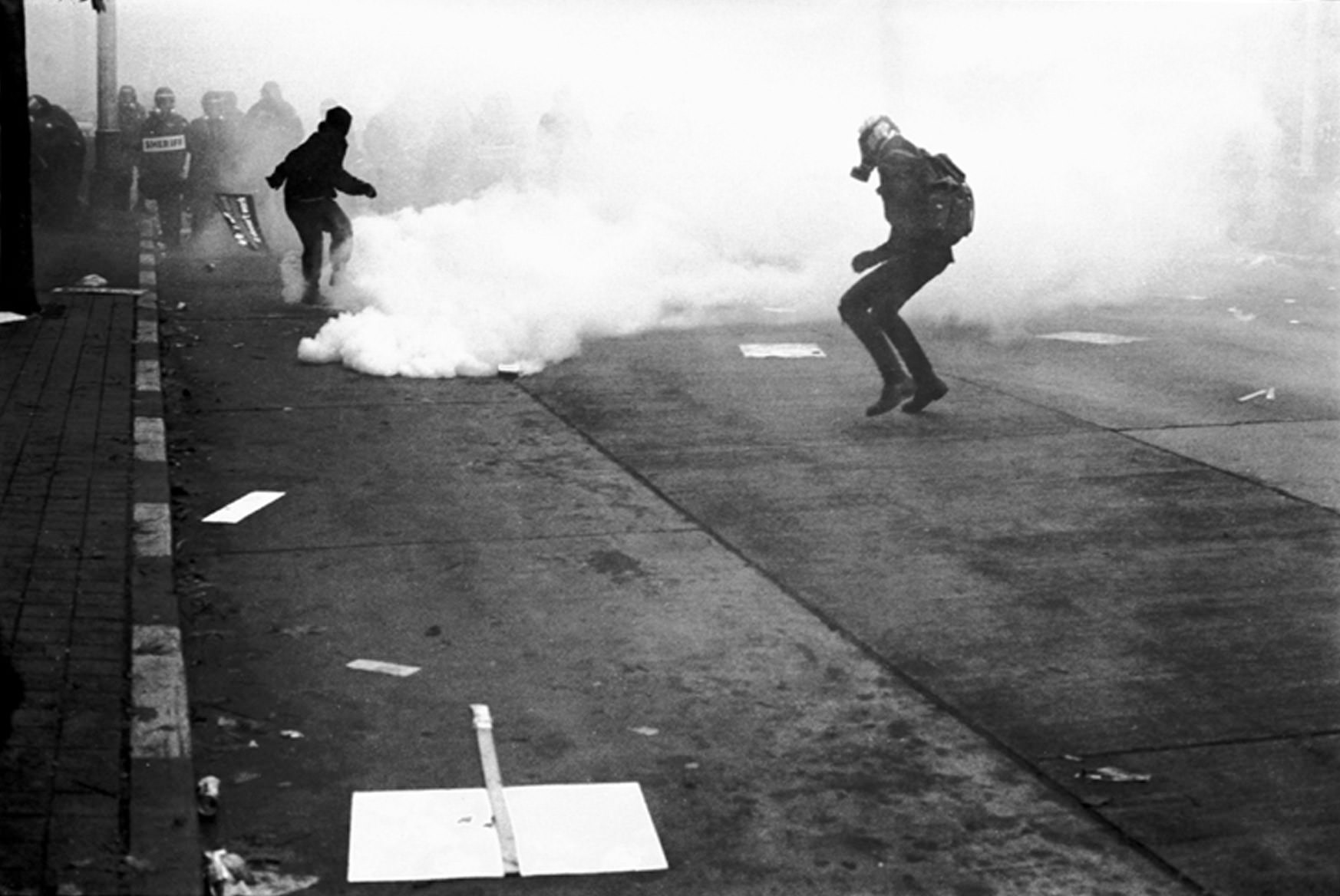 Returning tear gas to the police lines in Seattle, 1999.