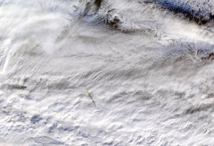 File - NASA's Moderate Resolution Imaging SpectroRadiometer (MODIS) instrument, aboard the Terra satellite, captured this true-color image showing the remnants of a meteor's passage, seen as a dark shadow cast on thick, white clouds on Dec. 18, 2018.