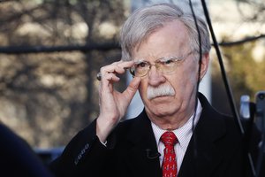 National security adviser John Bolton adjusts his glasses before an interview, Tuesday, March 5, 2019, at the White House in Washington.