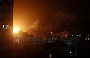 An explosion caused by Israeli airstrikes is seen from Hamas security building in Gaza City, Monday, March 25, 2019.