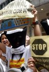 Protesters shouting slogans for migrant workers' rights outside an employment agency in Hong Kong last year. One in three households with children in Hong Kong employs a foreign domestic worker, who works an average of over 70 hours a week