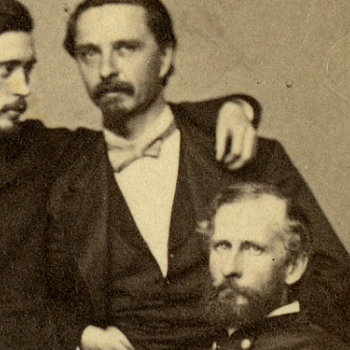 beige carte-de-visite with 4 men posed close together, two seated, with signatures on the bottom