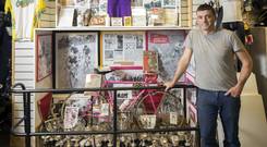 Austin Walsh with his collection of Shay Elliott memorabilia in the Quay Cycle Shop in Drogheda. Photo: Tony Gavin