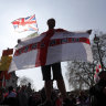 A Brexit supporter holds an England flag at Parliament Square in Westminster, London. 