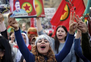 File - Kurdish demonstrators chants slogans as she holds a picture of the jailed Turkish Kurdish guerrilla leader Abdullah Ocalan, during a protest against the operation by the Turkish army aimed at ousting the U.S.-backed Kurdish militia from the area in Afrin, Syria, in front of the U.S. embassy in Aukar, east Beirut, Lebanon, Monday, Feb. 5, 2018.