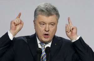 File - Ukrainian President Petro Poroshenko gestures while speaking at a meeting with supporters in Kiev, Ukraine, Tuesday, Jan. 29, 2019. Poroshenko declared his intention to run for re-election in March's presidential vote.