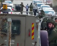 Soldiers arresting 14-year old Ahmer Eqneibi