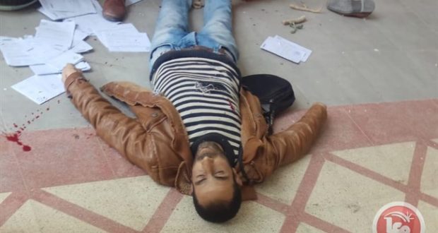 Yasser Fawzi Shweiki lies on the ground after being shot by the Israeli soldiers. Dozens of the court documents he was delivering can be seen scattered around his body.