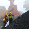 Chinese workers taking samples of imported Australian coal at a port in Rizhao.